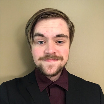 headshot of Harvey in a suit